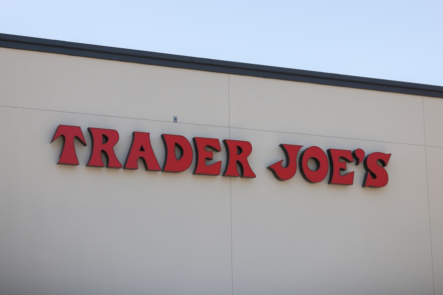 A Trader Joe's loge in red is on the side of a building