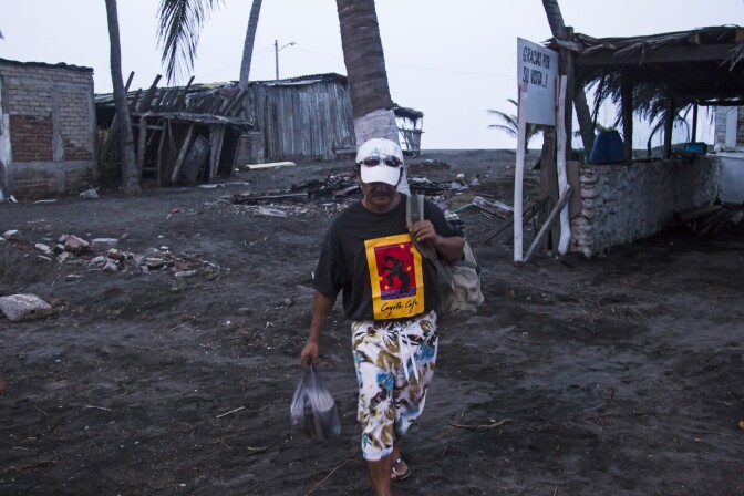 A man leaves his house in Boca de Pascuales, Colima State, Mexico, on October 22, 2015, before the arrival of hurricane Patricia. Fast-moving Patricia grew into an "extremely dangerous" major hurricane off Mexico's Pacific coast on Thursday, forecasters said, warning of possible landslides and flash flooding. 