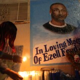 LOS ANGELES, CA - DECEMBER 29: Tritobia Ford lights candles at a memorial for her son, Ezell Ford, a 25-year-old mentally ill black man, at the site where he was shot and killed by two LAPD officers in August, on December 29, 2014 in Los Angeles, California. The long-awaited autopsy report, which was put on a security hold at the request of police and ordered by L.A. Mayor Eric Garcetti to be made public before the end of 2014, was released December 29.   (Photo by David McNew/Getty Images)
