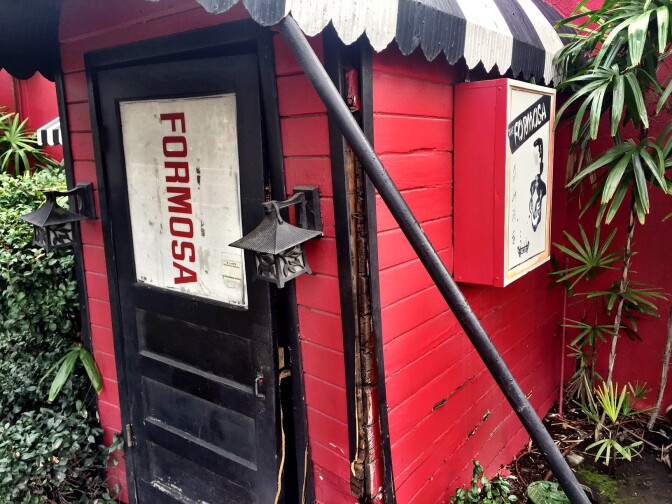 The front door of the historic but closed Formosa Cafe in West Hollywood is held closed, kinda, with a rope.