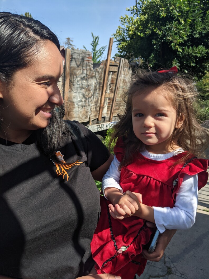Heidi Gonzalez Toledo holds her two-year-old daughter.