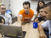Anthony Massari, a graduate researcher in Caltech's civil engineering department, discusses graphs from a Community Seismic Networks sensor during an all-day bilingual Risk Lab at Sotomayor Learning Academies on Saturday afternoon, Aug. 27 2016. Caltech's CSN distributes seismic sensors to volunteers free of charge across Southern California.