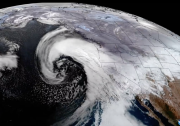 A swirling cloud mass is visible over the Atlantic Ocean nearly the U.S. West Coast