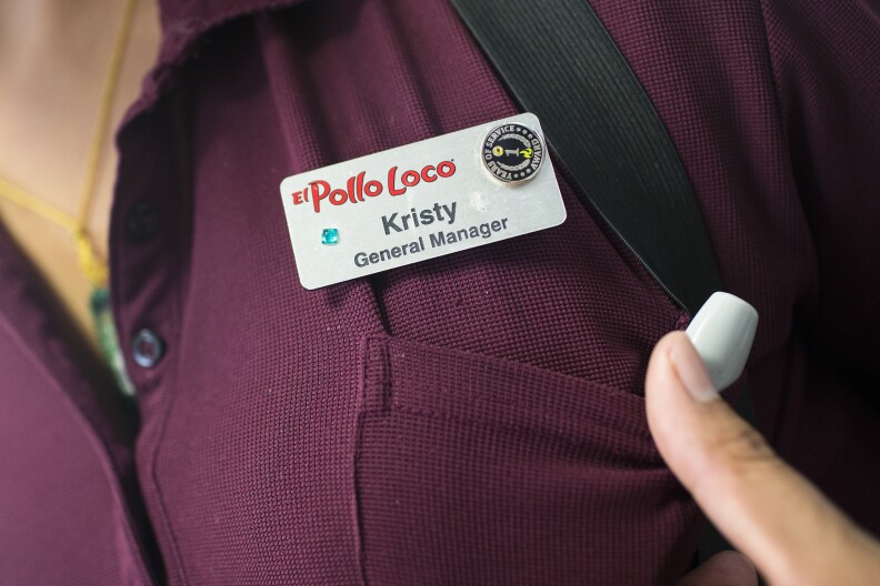 General Manager Kristy Ramirez decorated her name tag she recently received when she was promoted at one of Michaela Mendelsohn's six El Pollo Loco franchises she owns in Southern California on Wednesday afternoon, July 14, 2016.
