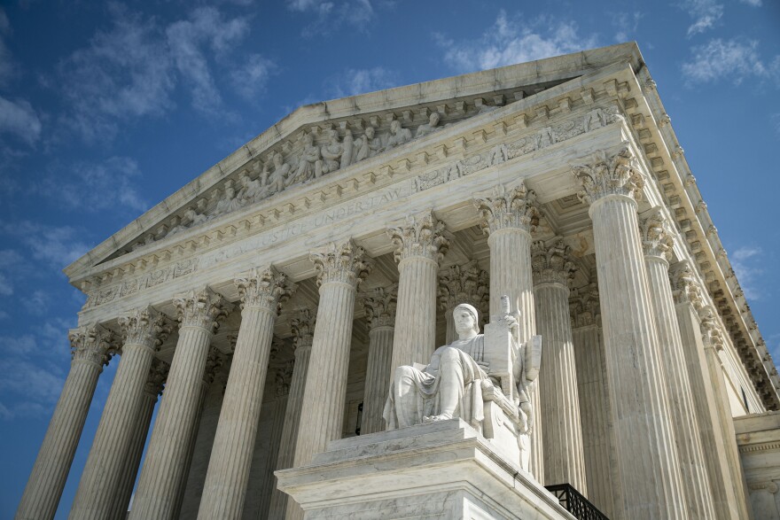 The Supreme Court on a sunny day. The buildings pillars are at the center of the image.