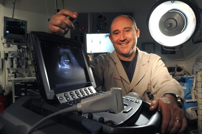 UC Irvine's Dr. Chris Fox brought portable ultrasounds into UCI's medical school training. He says the small devices save lives and money.
