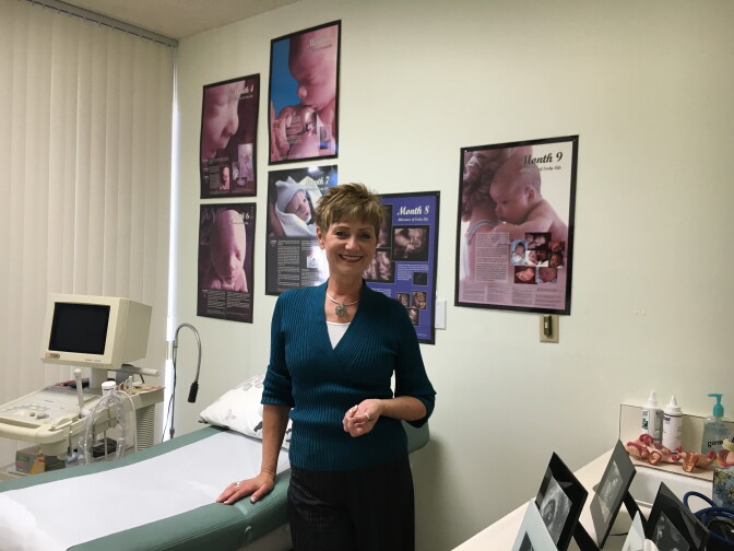 Lori Berg is the executive director of Foothills Pregnancy Resource Center in Duarte. The center's ultrasound room features posters of fetuses during different stages of development.