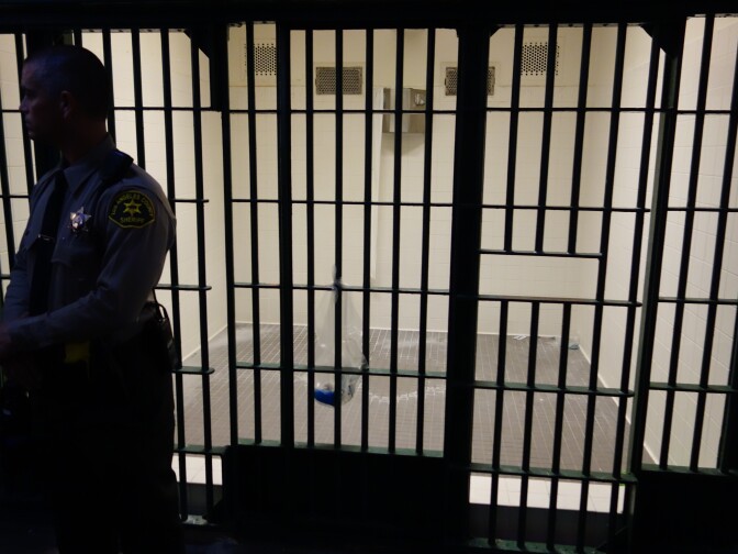                                A Los Angeles County Sheriff's Deputy stands in front of an empty cell at Men's Central Jail.