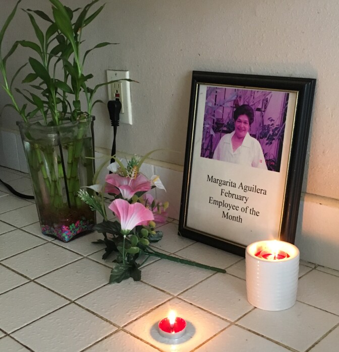Candles burn in Zoila Margarita Aguilera's kitchen on Oct. 24, 2016. The retired caregiver from El Salvador was among the 13 people who died in the crash of a USA Holiday casino tour bus on Saturday. 