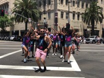 LA officials and the cast of On Your Feet christens the new diagonal crosswalk with a Conga line.