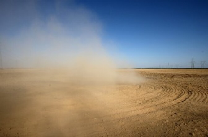 Dust billows as a farmer plows a dry field near Buttonwillow, California. Central Valley farmers and farm workers are suffering through the third year of the worsening California drought with extreme water shortages and job losses.