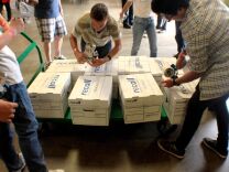 

Volunteers pack up thousands of pounds of food as part of a Rotary Club sponsored drive on Saturday at Second Harvest Food Bank in Riverside. 

