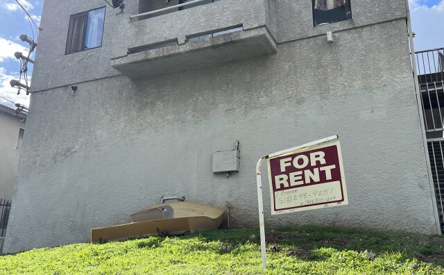 A "for rent" sign hangs near a discarded mattresses outside an apartment building in the city of Los Angeles. 