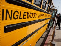 A student boards a bus maintained by the Inglewood Unified School District on February 28, 2012.