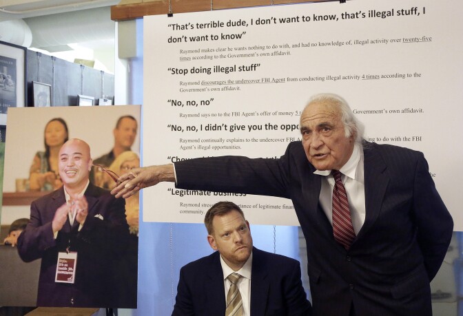 Tony Serra, right, speaks next to Curtis Briggs, both attorneys for Raymond "Shrimp Boy" Chow, pictured at left, at a news conference in San Francisco, Thursday, April 10, 2014. Chow, the leader of the Chinatown organization the FBI says is a front for organized crime, and state Sen. Leland Yee were arrested on March 26 as part of an FBI sting targeting political corruption and an alleged organized crime syndicate based in San Francisco's Chinatown. (AP Photo/Jeff Chiu)