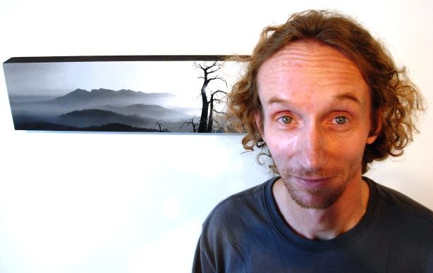 Todd Carpenter and one of his paintings from the "scaped" exhibit at LAUNCH Gallery.