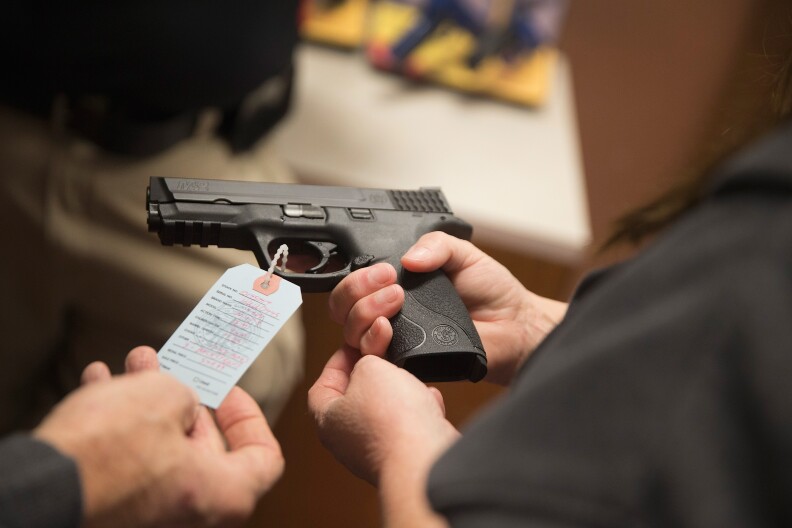 BRIDGETON, MO - NOVEMBER 12:  Customers shop for a handgun at Metro Shooting Supplies on November 12, 2014 in Bridgeton, Missouri. The suburban St. Louis store is located near Ferguson, Missouri where several weeks of sometimes violent protests erupted following the shooting death of Michael Brown by Ferguson police officer Darren Wilson on August 9th. The gun shop last week experienced a 300 percent increase in sales over the same period last year. About 60 percent of those sales were from first-time gun owners. The increase is attributed in part to concern from residents of additional outbreaks of violence if the grand jury investigating Brown's death does not find justification to prosecute Wilson for the shooting. The grand jurys decision is expected sometime in November.  (Photo by Scott Olson/Getty Images)2