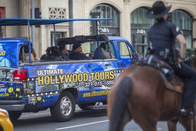 LOS ANGELES, CA - DECEMBER 06: Tourists pass a Los Angeles Police Department Mounted Platoon officer on Hollywood Boulevard as police and deputies step up security near the Hollywood/Highland Red Line Metro train station and other stops on December 6, 2016 in Los Angeles, California. An increase in security is in response to Federal and Los Angeles officials who say they were alerted by authorities in another country that an imminent and very specific threat has been made against the city's Red Line commuter rail system.  (Photo by David McNew/Getty Images)