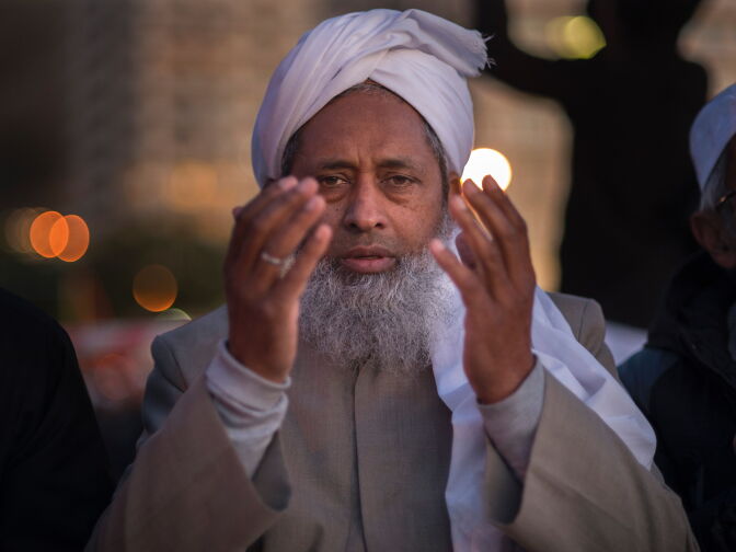 A Muslim prays as he attends the evening prayer at Three Anchor Bay in Cape Town on June 24, 2017, as Islamic leaders attempt to sight the new moon which would herald the end of the fasting month of Ramadan and the start of the Eid al-Fitr Festival.


 / AFP PHOTO / RODGER BOSCH        (Photo credit should read RODGER BOSCH/AFP/Getty Images)