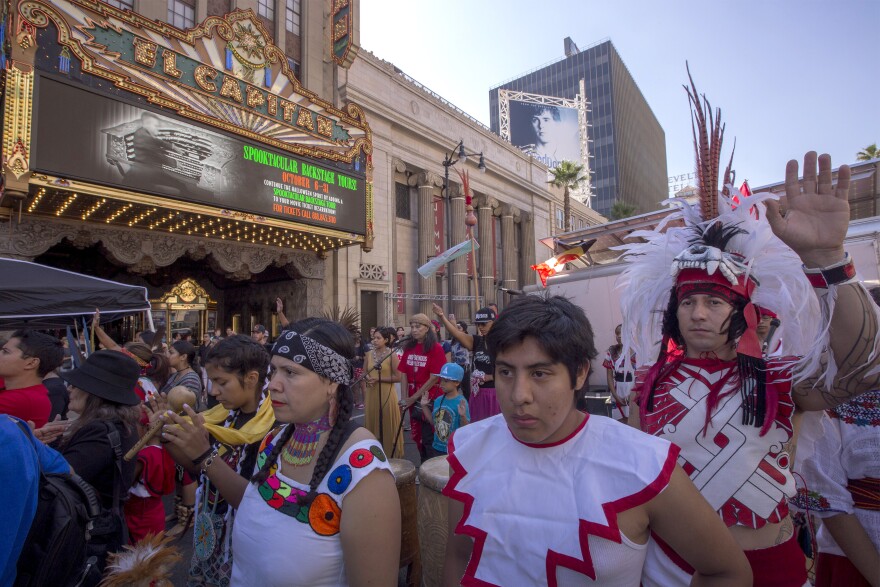 LOS ANGELES, CA - OCTOBER 08: Dancers from Anahuacalmecac International University Preparatory of North America school for indigenous students pray before dancing on Hollywood Boulevard near the El Capitan Theatre and Jimmy Kimmel Live Studio during an event celebrating Indigenous Peoples Day on October 8, 2017 in the Hollywood section of Los Angeles, California. Both the city and the county of Los Angeles have approved Indigenous Peoples Day to replace Columbus Day on each second Monday in October, starting no later than 2019. October 12 will be Italian American Heritage Day.  (Photo by David McNew/Getty Images)