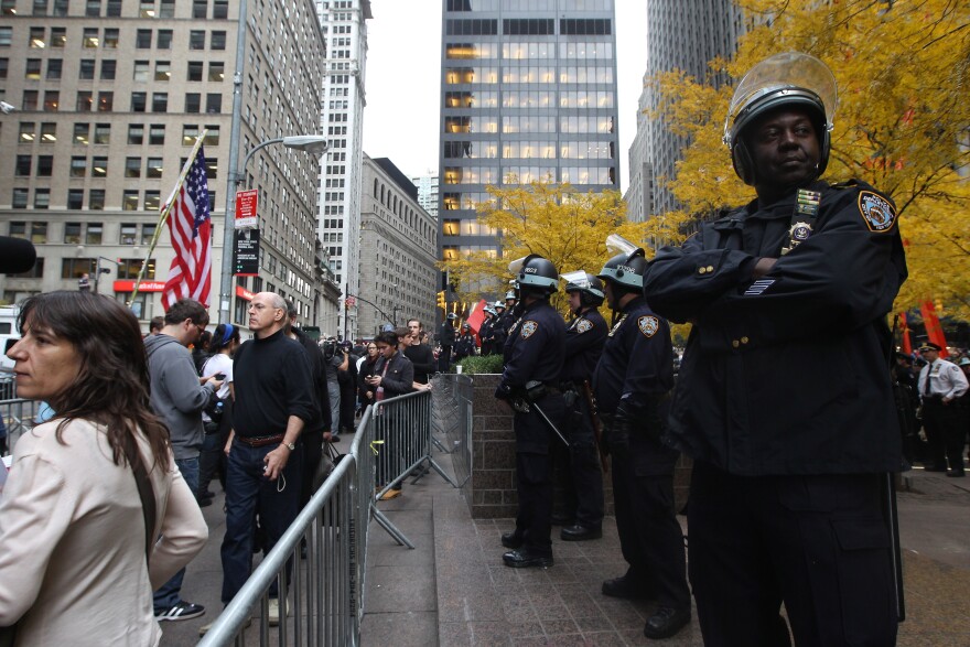 NEW YORK, NY - NOVEMBER 15:  Occupy Wall Street protesters and police stand outside Zuccotti Park after police removed the protesters from the park early in the morning on November 15, 2011 in New York City. Hundreds of protesters, who rallied against inequality in America, have slept in tents and under tarps since September 17 in Zuccotti Park, which has since become the epicenter of the global Occupy movement. The raid in New York City follows recent similar moves in Oakland, California, and Portland, Oregon.  (Photo by Mario Tama/Getty Images)