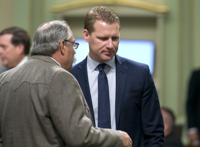 Assemblyman Frank Bigelow, R-O'Neals, talks with Assembly Republican Leader Chad Mayes, of Yucca Valley, Thursday, July 20, 2017, in Sacramento, Calif. Mayes has received criticism from some GOP members for his support of a cap-and-trade bill backed by Gov. Jerry Brown. (AP Photo/Rich Pedroncelli)