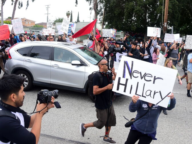 Protesters from Latino and Community groups make their way to East Los Angeles College in Monterey Park on May 5, 2016 to protest U.S. Democratic presidential candidate Hillary Clinton. Clinton campaigned in the Los Angeles area ahead of California's June 7 primary.