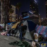 Robert King Geiser, 35 years-old, after 2 years living on the street, stands outside his tent next to the 110 Freeway, during the novel Coronavirus, COVID-19, pandemic in Los Angeles California on May 25, 2020. - On May 22, 2020 a federal judge issued a preliminary order requiring that  homeless people living under Los Angeles freeway overpasses and underpasses, be relocated for health and safety reasons. (Photo by Apu GOMES / AFP) (Photo by APU GOMES/AFP via Getty Images)