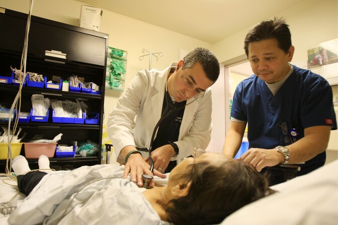 PANORAMA CITY, CA - JANUARY 28:  Dr. Jason Greenspan (L) and emergency room nurse Junizar Manansala care for a patient in the ER of Mission Community Hospital where doctors held a press conference outside on a class action lawsuit against the state of California by a coalition of emergency room physicians claiming that without additional funding, the entire emergency healthcare system is on the verge of collapse on January 28, 2009 in Panorama City, California. According to the coalition, the cost of providing emergency room treatment has nearly doubled over the past decade and patient load increased by more than 28 percent while Medi-Cal reimbursements have remained largely unchanged. During that time, 85 California hospitals in California have closed and an additional 55 facilities have shut down their emergency rooms.  California now reportedly ranks worst in the nation for access emergency care and last in emergency rooms per capita. California has seven emergency rooms per million people while the national average is 20 emergency rooms per million people.  (Photo by David McNew/Getty Images) *** Local Caption *** Junizar Manansala;Jason Greenspan