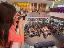 A USC student takes a photo of fellow students and faculty during the third presidential debate at USC Annenberg's Wallis Annenberg Hall on Oct. 19, 2016. 