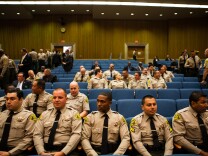 Members of the Los Angeles County sheriff's department wait for Undersheriff Paul Tanaka's hearing to begin with the County Board of Supervisors on July 27, 2012.