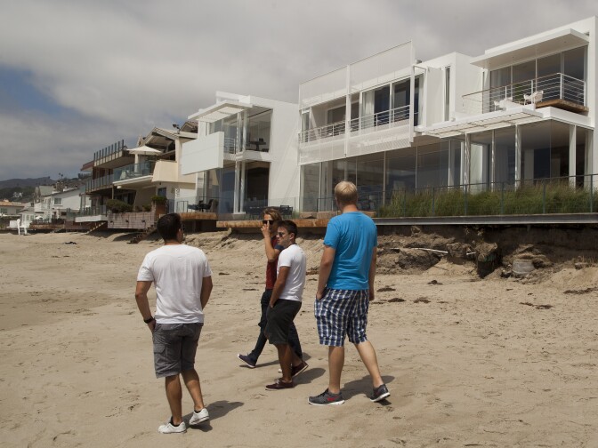 Tourists walk along Carbon Beach in Malibu, which used to have limited public access.