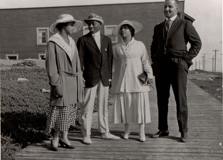 Two couples stand on a walkway at the Bruce's Beach resort in Manhattan Beach, Calif., circa 1920. A few years later, the city condemned the property and seized it from its Black owners.