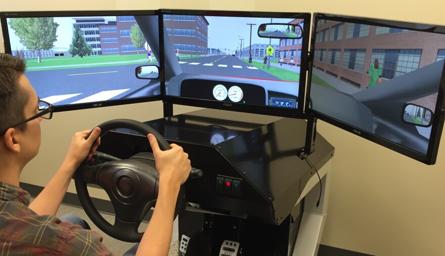 UCSD Center for Medicinal Cannabis Research staffer Kevin McShea at the wheel of a simulator that will be used for driving-while-impaired studies.