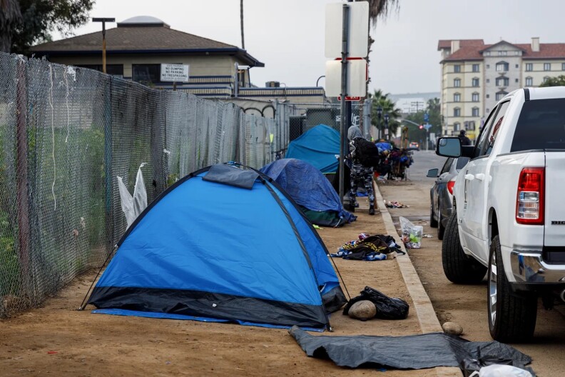 A set of tents on a curb in San Diego CA.
