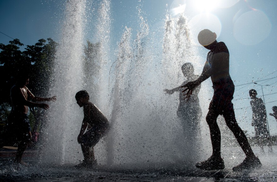 Children play in a fountain during a hot summer day in Santiago's main square, on February 2, 2016. AFP PHOTO/ MARTIN BERNETTI / AFP / MARTIN BERNETTI        (Photo credit should read MARTIN BERNETTI/AFP/Getty Images)