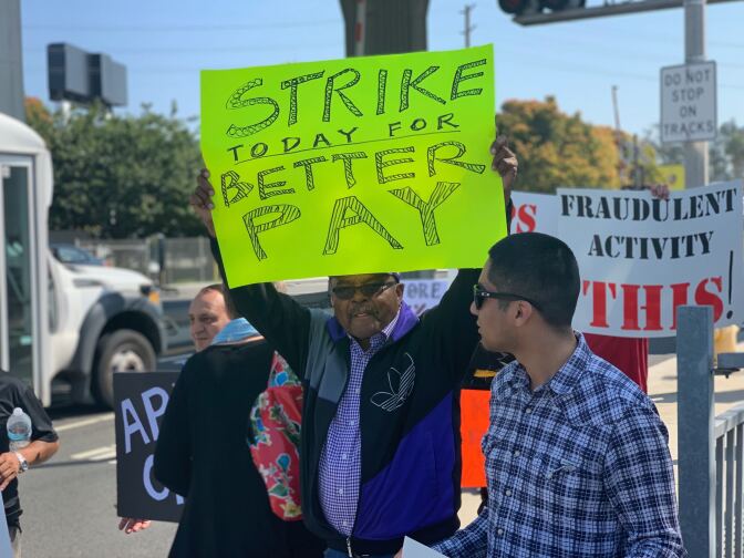 A protestor strikes for higher wages at Uber's Redondo Beach offices.
