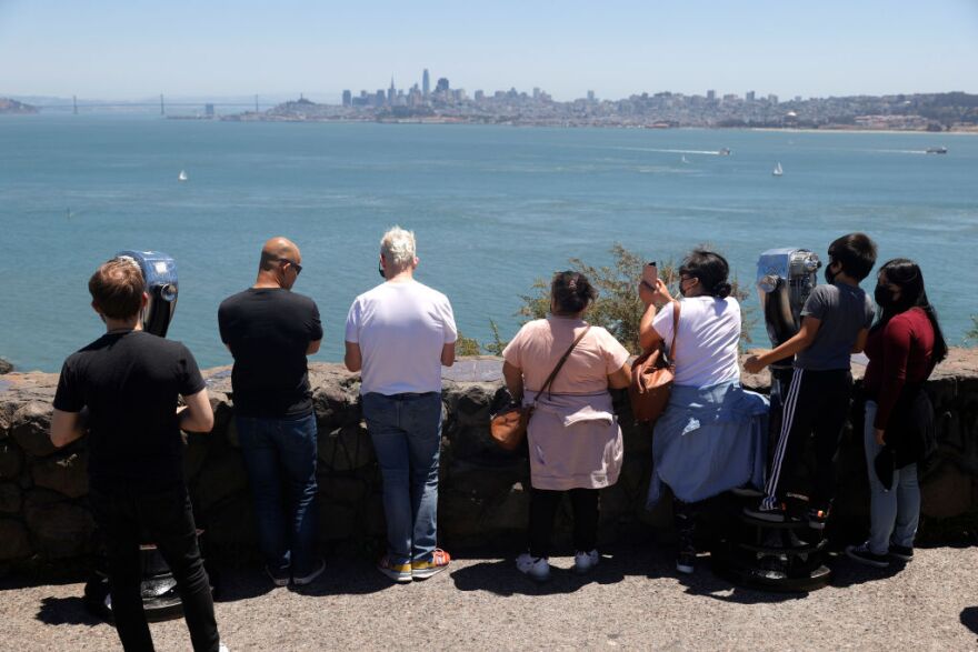 SAUSALITO, CA - JUNE 15: Tourists gather at the Golden Gate Bridge vista point on June 15, 2021 in Sausalito, California. California, the first state in the U.S. to go into lockdown at the beginning of the coronavirus pandemic, is lifting nearly all COVID-19 restrictions today with the exceptions of mask wearing and social distancing on public transportation, hospitals, K-12 schools indoors and some retail stores. (Photo by Justin Sullivan/Getty Images)