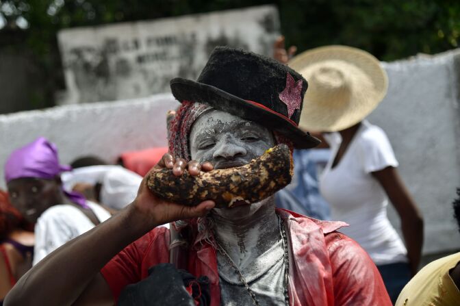 A devotee pretending to be the spirit known as a Gede looks on during a ceremony honoring the Haitian voodoo spirits of Baron Samdi and Gede on the Day of the Dead in Port-au-Prince, Haiti on November 1, 2016.