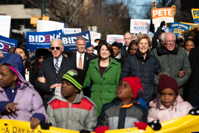 COLUMBIA, SC - JANUARY 20: Democratic presidential candidates, former Vice President Joe Biden, left, Sen. Amy Klobuchar (D-MN), Sen. Elizabeth Warren (D-MA), and Sen. Bernie Sanders (I-VT), right, march down Main St. to the King Day at the Dome event on January 20, 2020 in Columbia, South Carolina. The event, first held in 2000 in opposition to the display of the Confederate battle flag at the statehouse, attracted more than a handful of Democratic presidential candidates to the early primary state. (Photo by Sean Rayford/Getty Images)