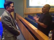 Anaheim police chief hiring consultant Stuart Satow (left) continues talking with residents after a public forum held to listen to community feedback.
