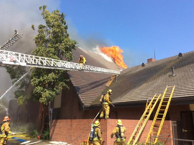 A brush fire in Glassell Park spread to the roof of a nearby church on Tuesday, July 7, 2015. 