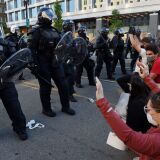 Protesters kneel and hold up their hands in front of a row of police officers in riot gear during a demonstration against the death of George Floyd at a park near the White House on June 1, 2020 in Washington, DC. - Police fired tear gas outside the White House late Sunday as anti-racism protestors again took to the streets to voice fury at police brutality, and major US cities were put under curfew to suppress rioting.With the Trump administration branding instigators of six nights of rioting as domestic terrorists, there were more confrontations between protestors and police and fresh outbreaks of looting. Local US leaders appealed to citizens to give constructive outlet to their rage over the death of an unarmed black man in Minneapolis, while night-time curfews were imposed in cities including Washington, Los Angeles and Houston. (Photo by Olivier DOULIERY / AFP) (Photo by OLIVIER DOULIERY/AFP via Getty Images)