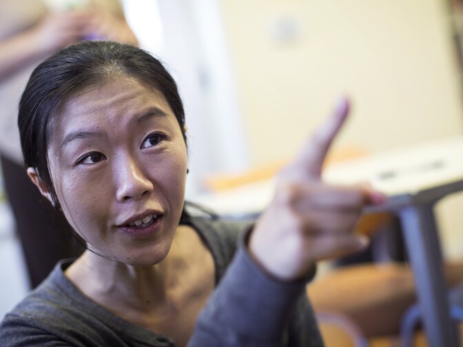 Samantha Chang, a tutor with AmeriCorps VISTA, spends time with students playing Wii before a summer program begins at School on Wheels in Skid Row on Monday afternoon, June 15, 2015.