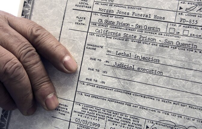 The cause of death is listed as 'lethal injection' on a copy of the death certificate of executed killer Manny Babbitt in this file photo taken January 12, 2005 on the steps of the California State building in San Francisco. On Wednesday, a U.S. District Court judge ruled the state's death penalty is unconstitutional, following a similar ruling in Northern California that has kept the death penalty on hold in California for years.