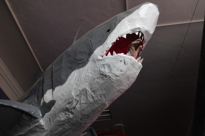 A cardboard shark hangs from the ceiling at the entrance of Calder's rad pad.