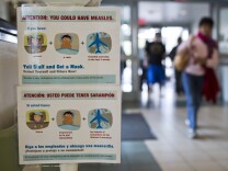 Posters list measles symptoms at the entry points of Olive View UCLA Medical Center in Sylmar on Monday, Jan. 26. The hospital has posted the signs after the recent measles outbreak in Southern California.