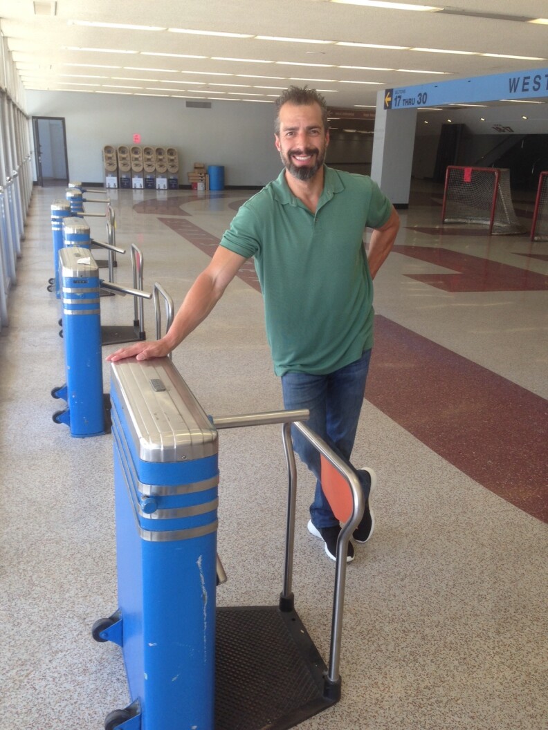 A Martinez standing next to his favorite item - the turnstile 