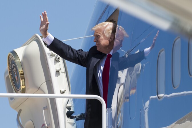 US President Donald Trump waves as he boards Air Force One prior to departing from Andrews Air Force Base in Maryland, April 18, 2017, as he travels to Wisconsin. / AFP PHOTO / SAUL LOEB        (Photo credit should read SAUL LOEB/AFP/Getty Images)