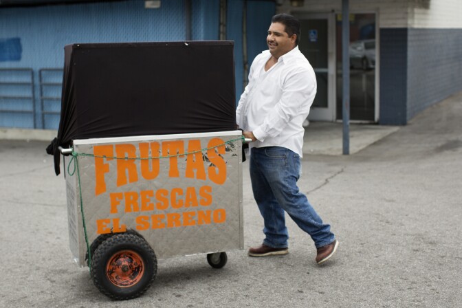 Delfino Flores unloads his cart from a pickup truck on Tuesday morning, Nov. 11, 2014.